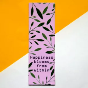 roze boekenlegger met daarom verschillende groene blaadjes, met onderin de tekst 'happiness blooms from within '