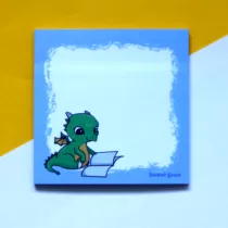 sticky notes met paarse rand met daarop een groene draak die een boek leest